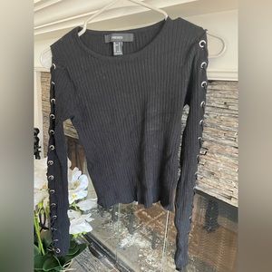 Black top with gold rings along sleeves